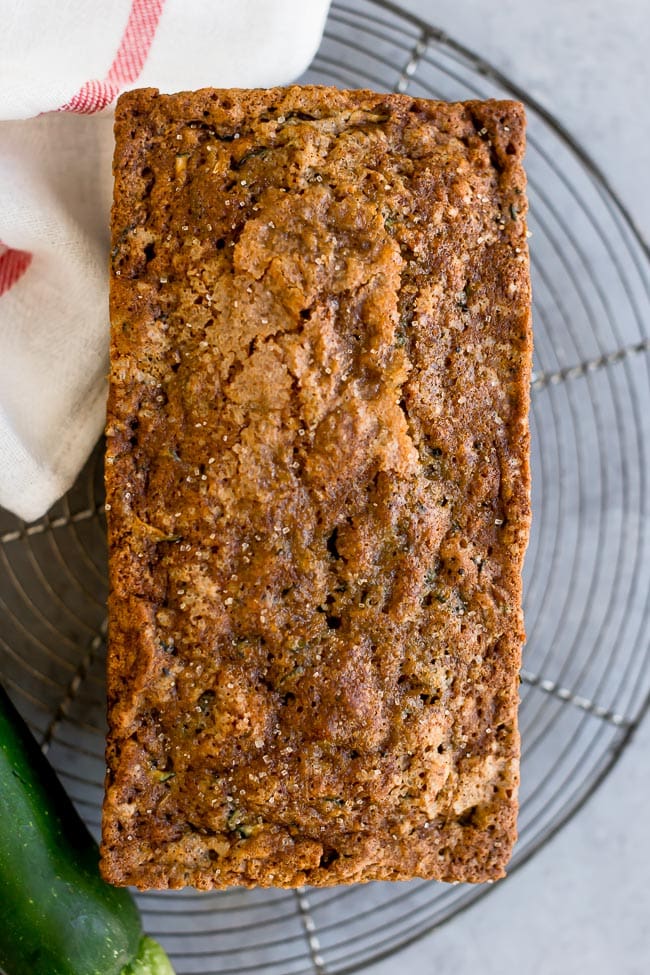 loaf of zucchini bread cooling on wire cooling rack. 