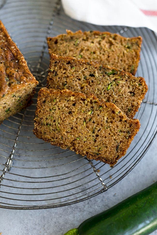 Zucchini Bread sliced on cooling rack.