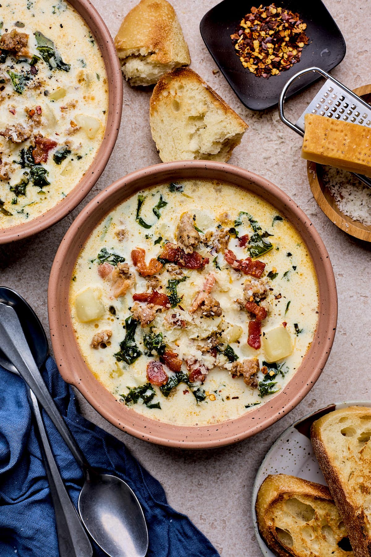 zuppa toscana soup in bowls with crusty bread. 