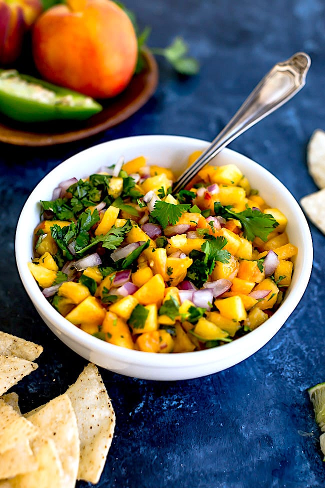 Easy Peach Salsa in a bowl with spoon