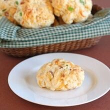 Cheddar biscuits with bacon and onion on plate and in basket