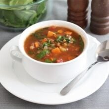 sweet potato lentil soup in soup bowl with spoon