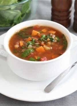 sweet potato lentil soup in soup bowl with spoon