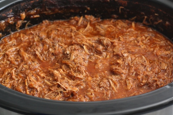 slow cooker pulled pork in crock pot ready to serve
