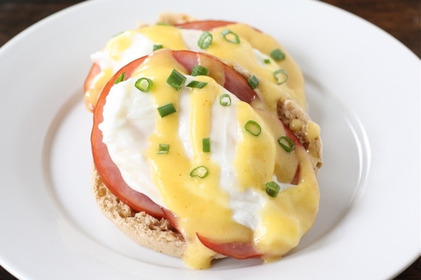 Eggs Benedict on plate with hollandaise sauce