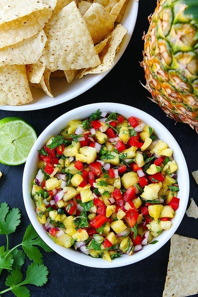 fresh pineapple salsa in bowl with chips.