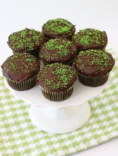 chocolate-zucchini-cupcakes1 chocolate zucchini cupcakes with sprinkles on cake plate.