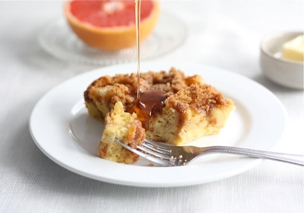 Baked French toast drizzled with syrup on plate