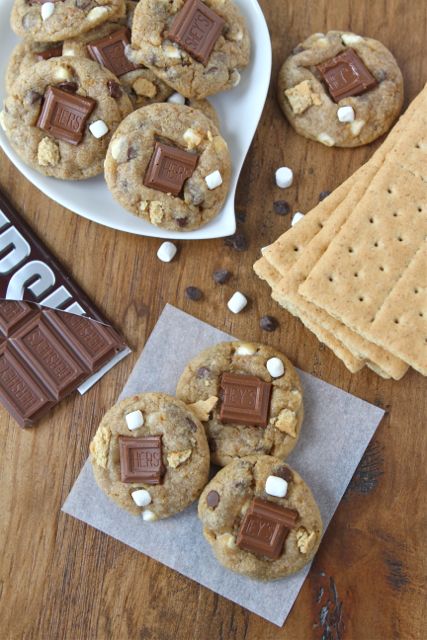 S\'mores cookies, chocolate bar, and graham crackers on a wooden table