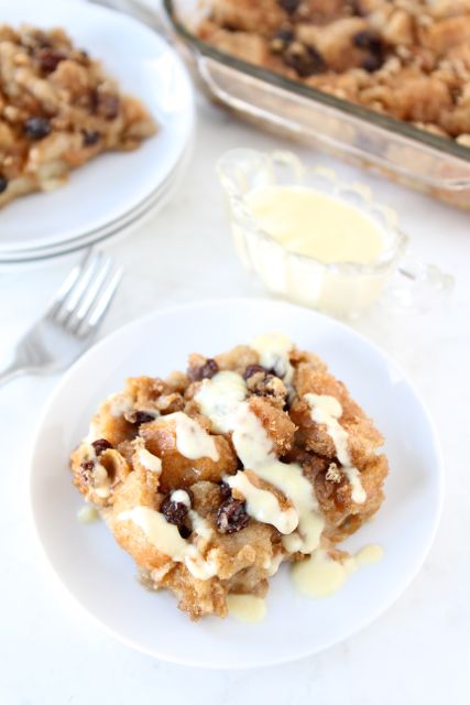 bread pudding slices plated and drizzled with bread pudding sauce