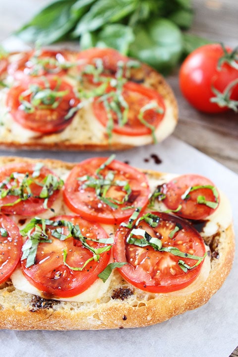 Caprese Garlic Bread Recipe made with fresh mozzarella, tomatoes, basil, and balsamic glaze. Everyone loves this easy garlic bread!