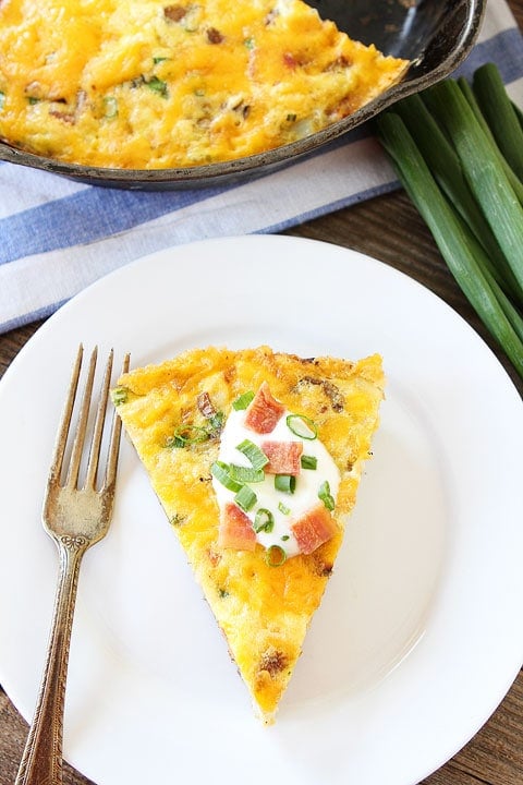 Potato Frittata slice with sour cream and onions on top