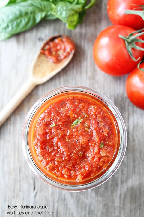 Easy Homemade Marinara Sauce in glass dish with fresh tomatoes and basil