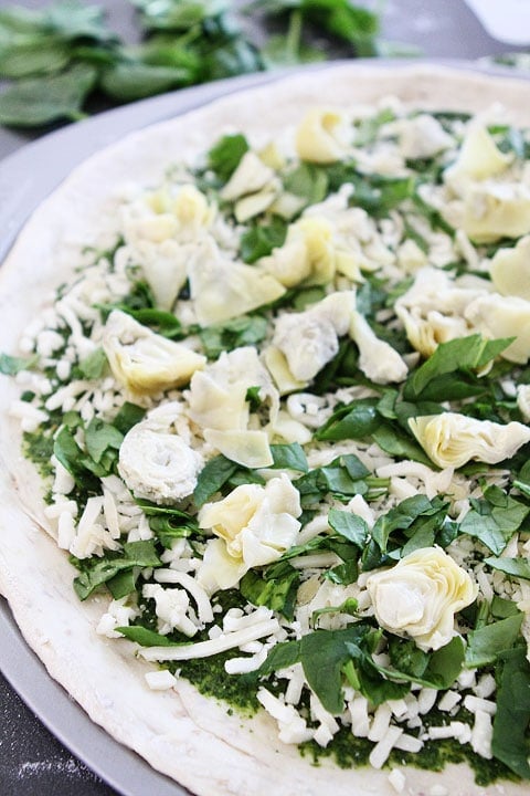 Spinach Artichoke Pesto Pizza Recipe on twopeasandtheirpod.com