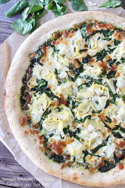 Spinach Artichoke Pesto Pizza Recipe on twopeasandtheirpod.com I bet you can't eat just one slice!