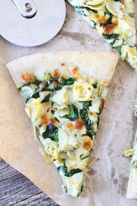 Spinach Artichoke Pesto Pizza Recipe on twopeasandtheirpod.com This vegetarian pizza is always a crowd pleaser!