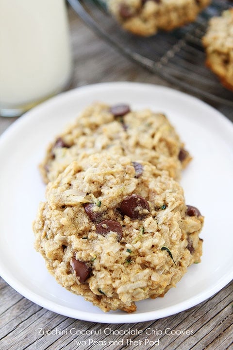 Zucchini Coconut Chocolate Chip Cookie Recipe are the perfect cookies for using up garden zucchini. You will LOVE these healthy cookies! #zucchini #zucchinicookies #cookies #recipe #dessert #vegetarian #baking #chocolatechip Oatmeal zucchini cookies with chocolate chips on plate