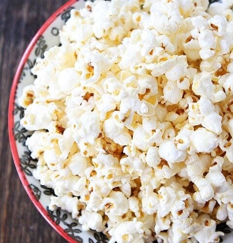 Kids cook popcorn at home in a popcorn maker Stock Photo