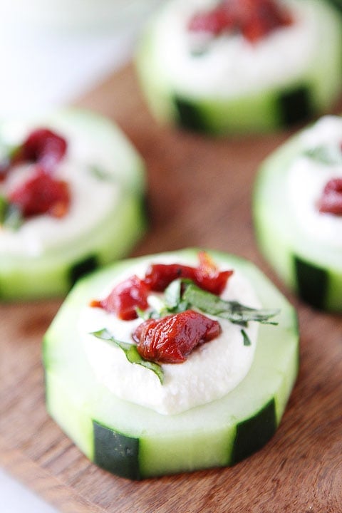 Cucumber Canapés with Whipped Feta, Sun-Dried Tomatoes and Basil on twopeasandtheirpod.com A simple holiday appetizer!