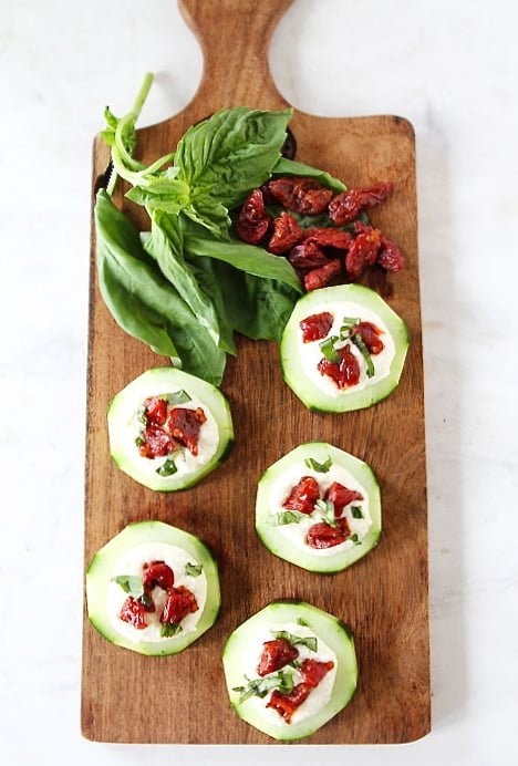 Cucumber Canapés with Whipped Feta, Sun-Dried Tomatoes and Basil on twopeasandtheirpod.com #recipe