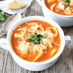 creamy tortellini soup in soup bowl garnished with basil