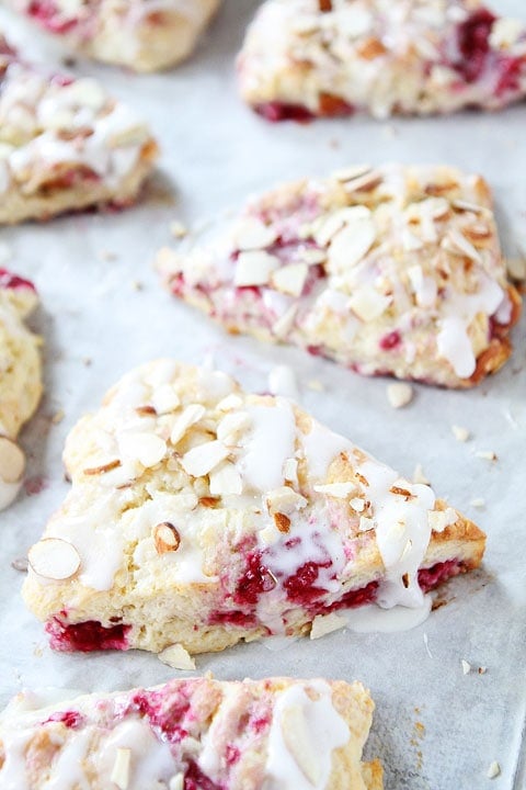 Raspberry Almond Scones with a juicy raspberries, a sweet almond glaze, and sliced almonds. They are perfect for breakfast and brunch.