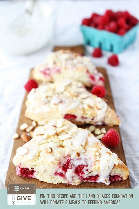 Raspberry Almond Scones are tender scones with raspberries and drizzled with a sweet almond glaze and almond slices. They are perfect for breakfast and brunch.