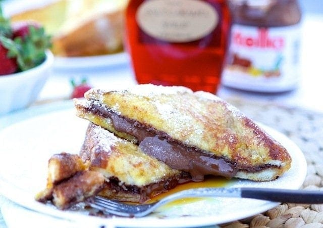 Nutella Stuffed French Toast Recipe on twopeasandtheirpod.com. This decadent French toast recipe is a real treat! 