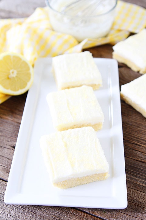 Lemon Sugar Cookie Bars Recipe on twopeasandtheirpod.com. Perfect bars for entertaining! Love the lemon cream cheese frosting! #lemon #dessert