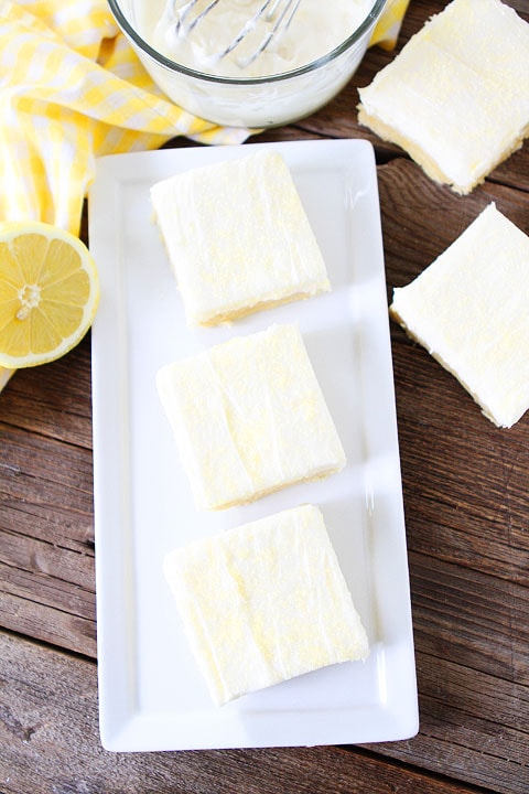 Lemon Sugar Cookie Bars Recipe on twopeasandtheirpod.com. Sugar cookie bars with lemon cream cheese frosting! A favorite at our house! #lemon #bars #dessert