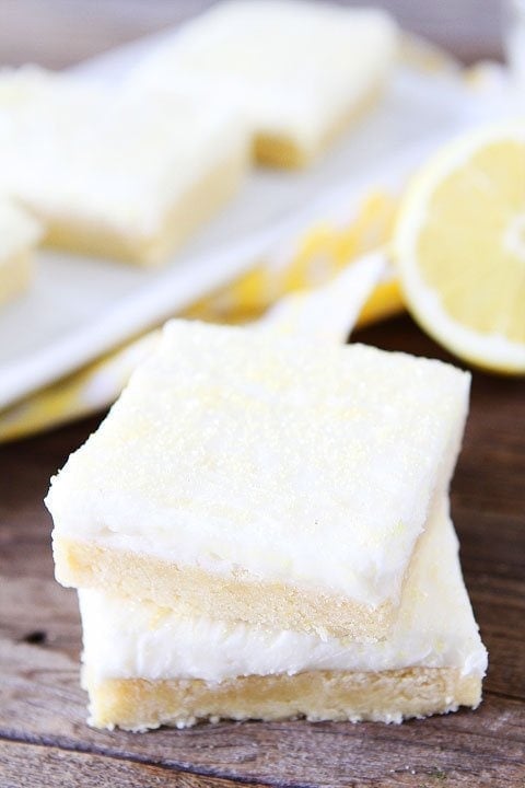 Lemon Sugar Cookie Bars Recipe on twopeasandtheirpod.com. Perfect bars for parties! Love the lemon cream cheese frosting! #lemon #dessert