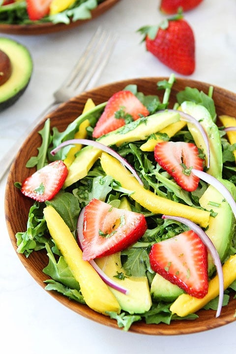Mango, Strawberry, and Avocado Arugula Salad Recipe on twopeasandtheirpod.com. This gorgeous salad is simple to make and perfect for summer! #salad #glutenfree #vegan