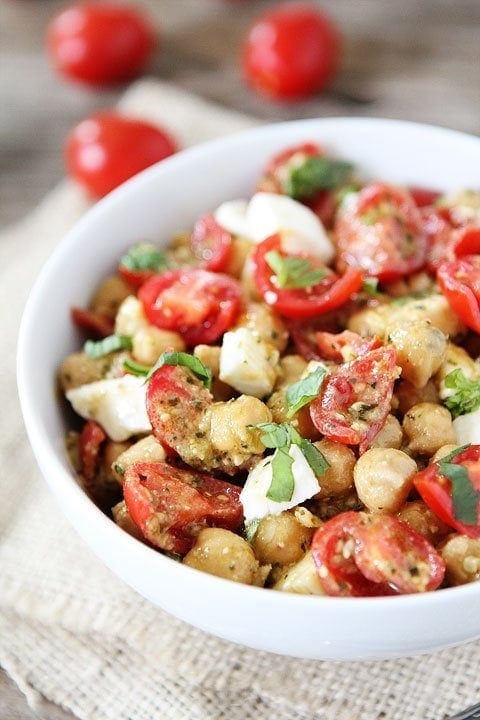 Chickpea, Pesto, Tomato, and Mozzarella Salad Recipe on twopeasandtheirpod.com Only 4 ingredients needed to make this healthy salad! #salad