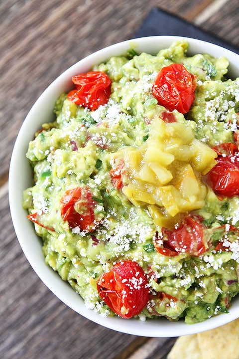 Green Chile and Roasted Tomato Guacamole Recipe on twopeasandtheirpod.com This guacamole is loaded with flavor! #avocado #appetizer
