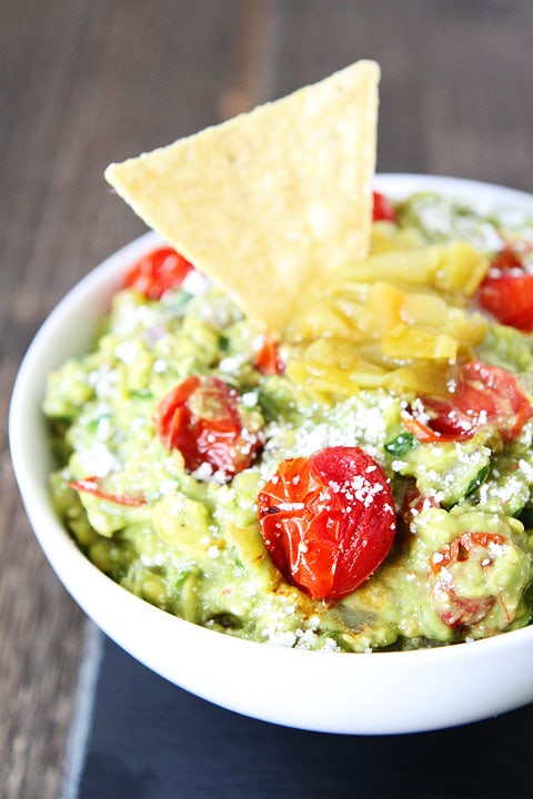 Green Chile and Roasted Tomato Guacamole Recipe on twopeasandtheirpod.com This guacamole recipe is a favorite at our house! #appetizer #glutenfree