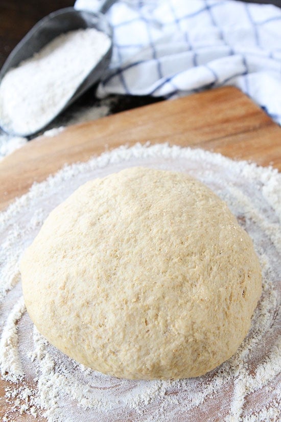 Easy Whole Wheat Pizza Dough Recipe on twopeasandtheirpod.com The BEST whole wheat pizza dough recipe and it's easy too! #pizza