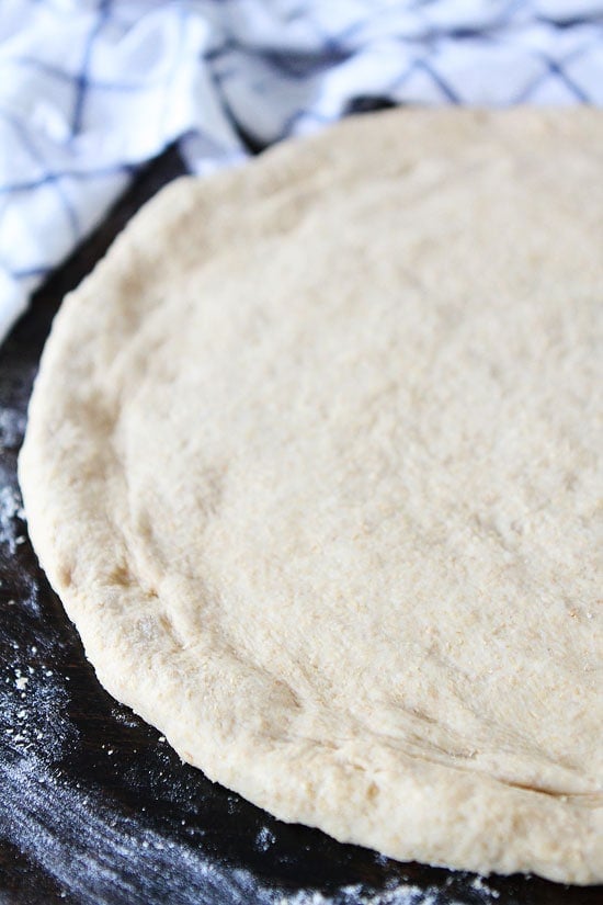 Easy Whole Wheat Pizza Dough Recipe on twopeasandtheirpod.com The BEST whole wheat pizza dough recipe and it's easy too! 