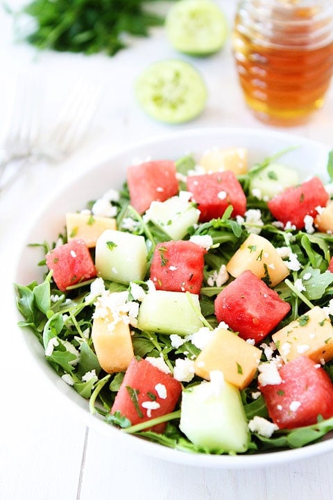 Melon Arugula Salad with Honey Lime Dressing Recipe on twopeasandtheirpod.com Love this refreshing summer salad! #salad #glutenfree