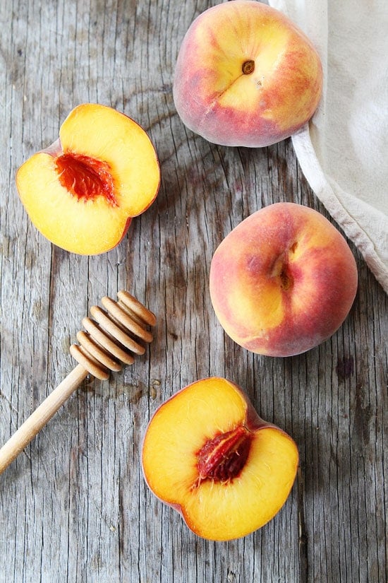 Honey Peach Muffins with Oat Streusel Topping Recipe on twopeasandtheirpod.com