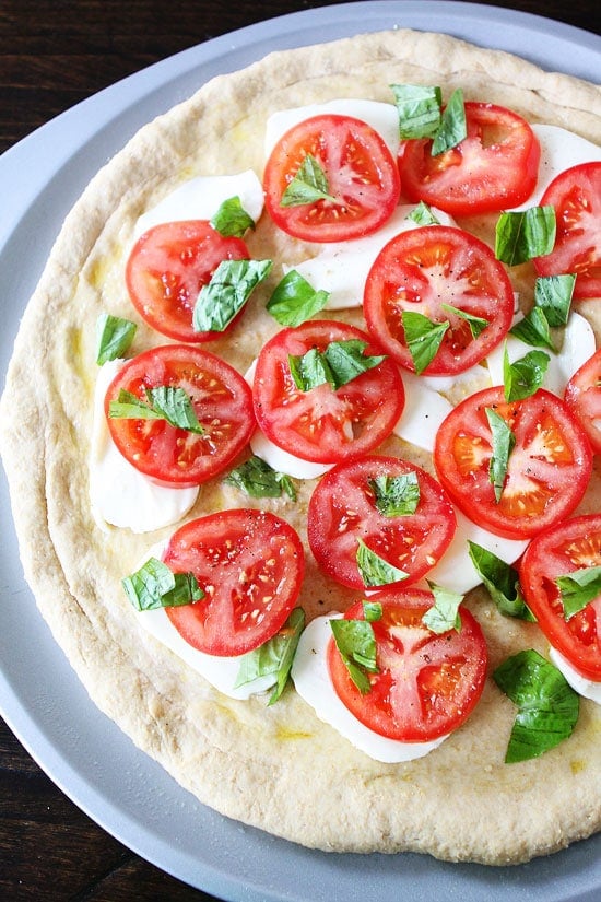 Caprese Pizza Recipe on twopeasandtheirpod.com We love this easy pizza!