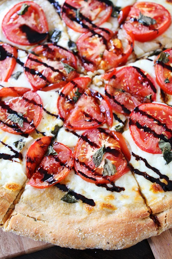 Caprese Pizza Recipe on twopeasandtheirpod.com One of our very favorite pizza recipes! #pizza