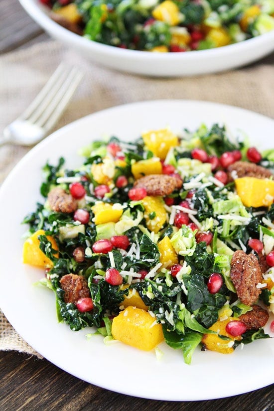 Kale and Brussels Sprouts Salad with Butternut Squash, Pomegranate, and Candied Pecans Recipe on twopeasandtheirpod.com