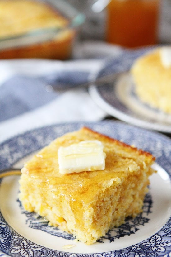 slice of cornbread from scratch with butter and honey