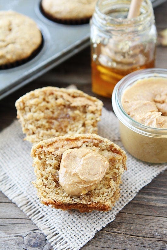 Peanut Butter, Banana, and Honey Muffins Recipe on twopeasandtheirpod.com These healthy muffins are great for breakfast or snack time! Kids and adults love them! peanut butter muffins slathered with peanut butter and honey