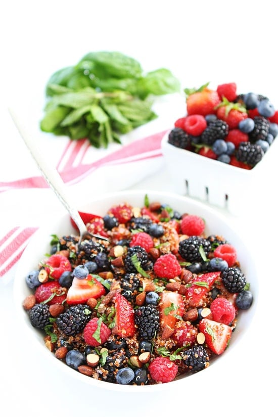 Berry Quinoa Salad with almonds in bowl with spoon.