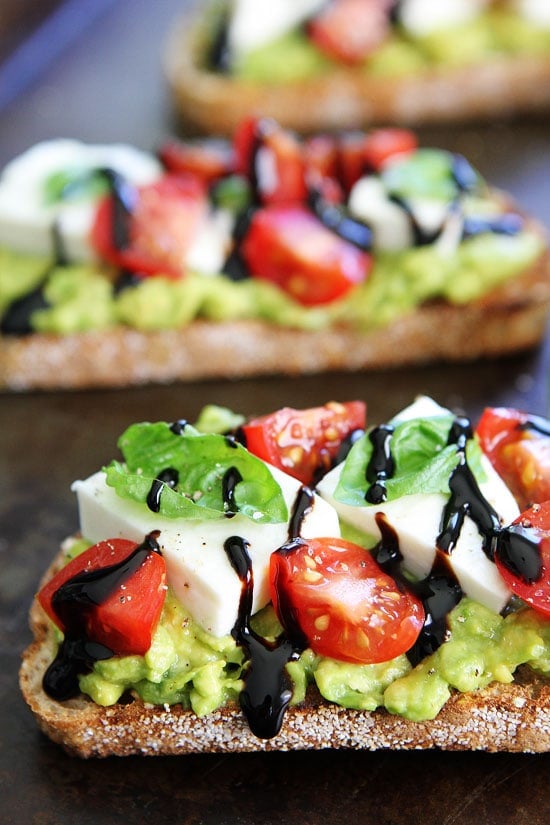 Caprese Avocado Toast Recipe on twopeasandtheirpod.com Caprese salad meets avocado toast! This is the BEST avocado toast! Caprese Avocado Toast Recipe