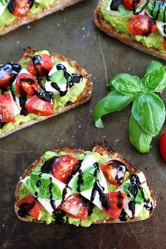 Caprese Avocado Toast Recipe on twopeasandtheirpod.com Caprese salad meets avocado toast! This is the BEST avocado toast and it's super simple to make! Caprese Avocado Toast Recipe