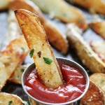 Parmesan potato wedges with garlic dipped in ketchup