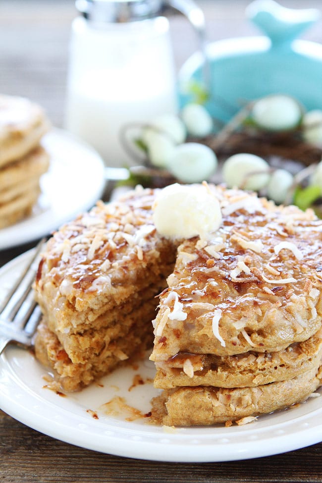 Plate of stacked Toasted Coconut Pancakes with butter