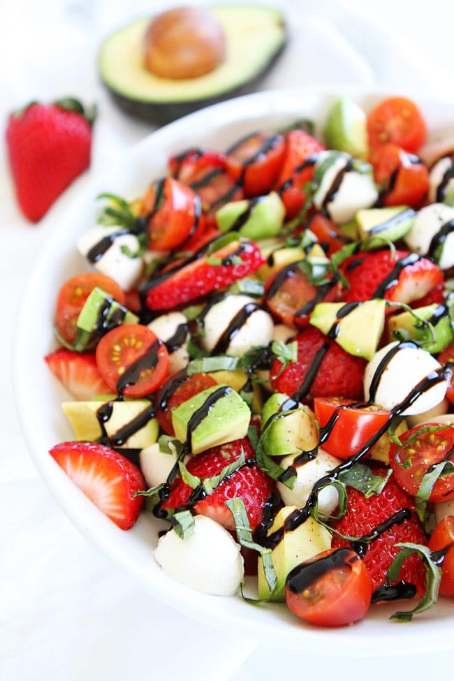 Caprese Salad with mozzarella, basil, tomatoes, strawberries, avocado and balsamic 